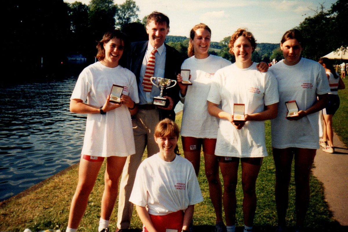 5 women with medals and coach holding silver trophy