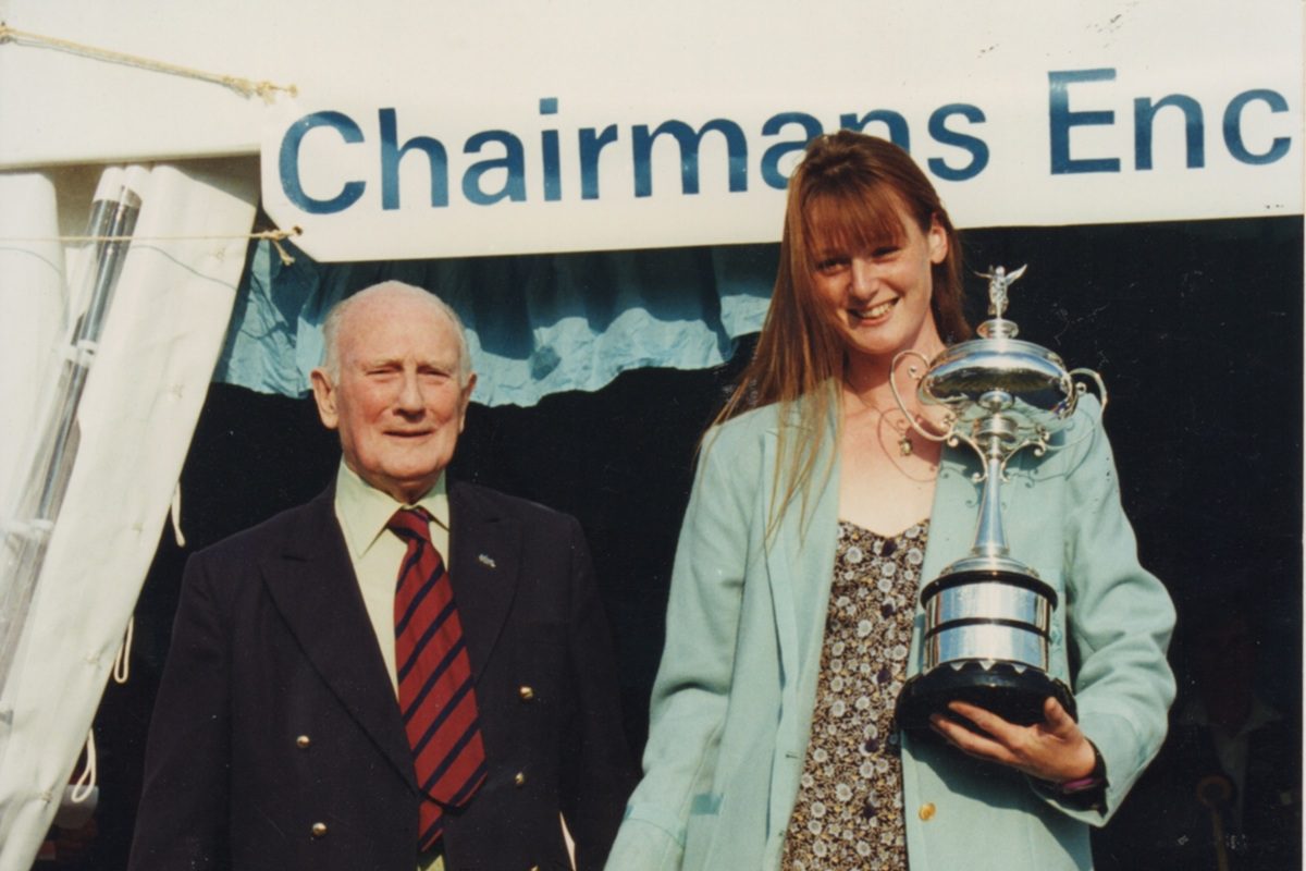 woman rower with large silver trophy