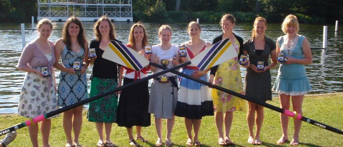 9 women with trophy and crossed blades