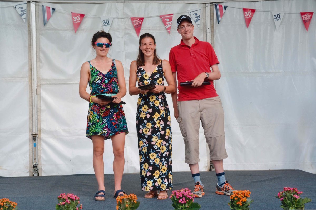 2 women and their coach with trophy