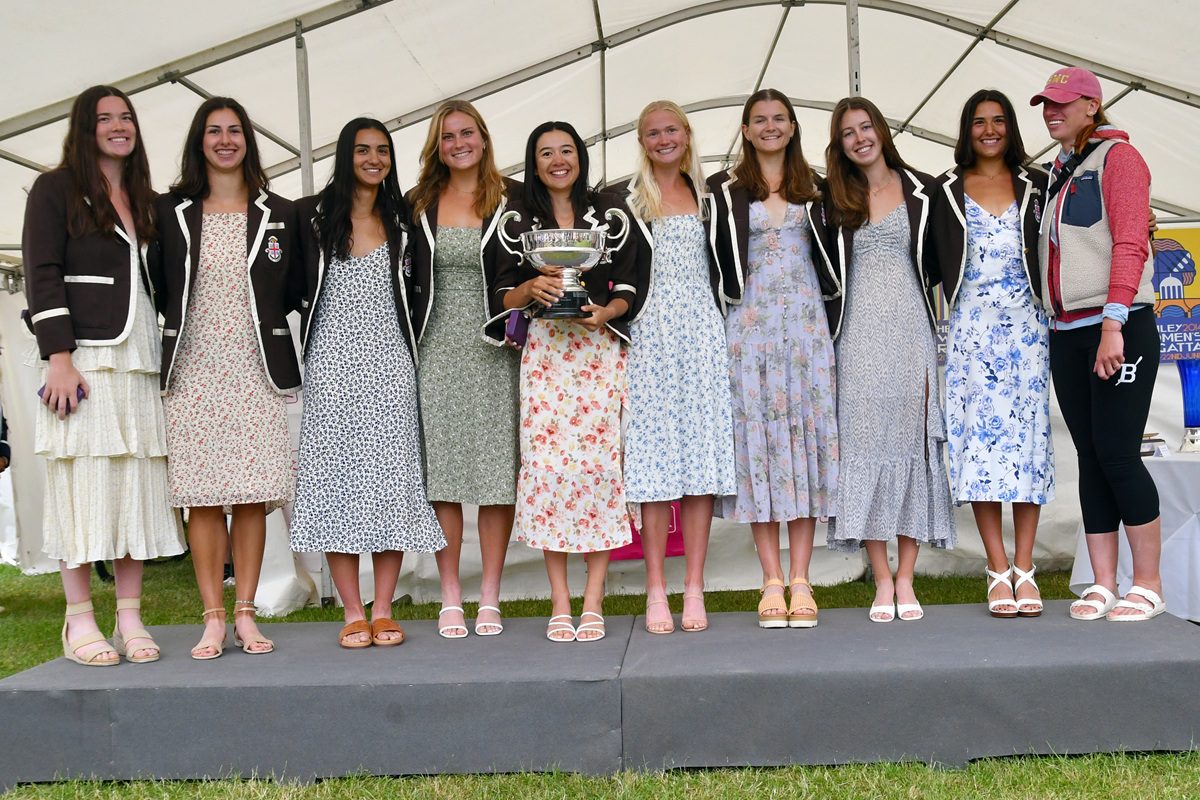 Women's eight with coach and trophy