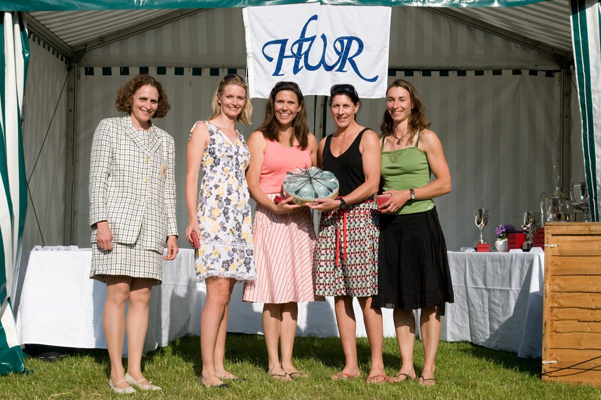 4 women being presented with a trophy with HWR banner behind them
