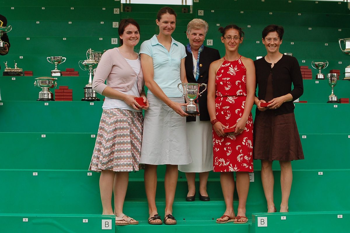 4 female athletes with a silver trophy
