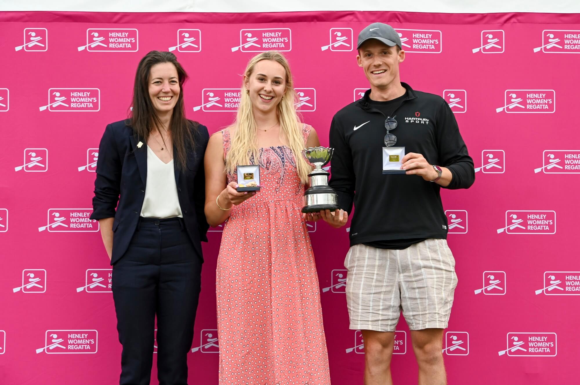 Young woman with medal and trophy