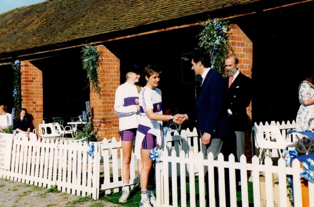 2 women being presented with medals