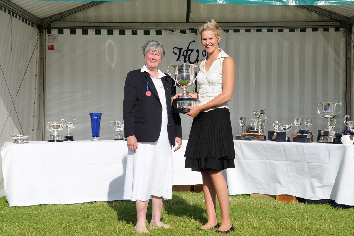 woman being presented with large silver trophy 2008