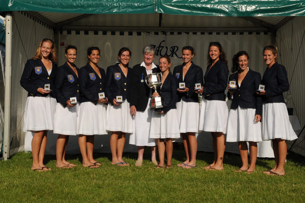 Women in navy blazers and white skirts with medals and trophy 2008