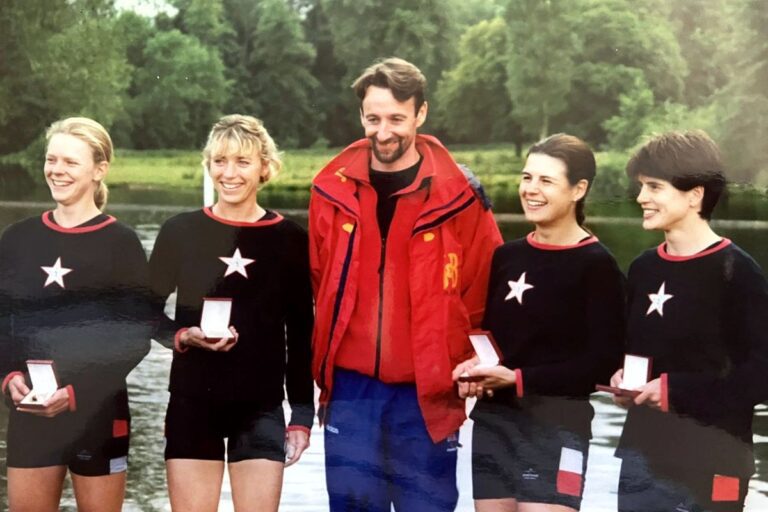 4 women with medals and man in red coat