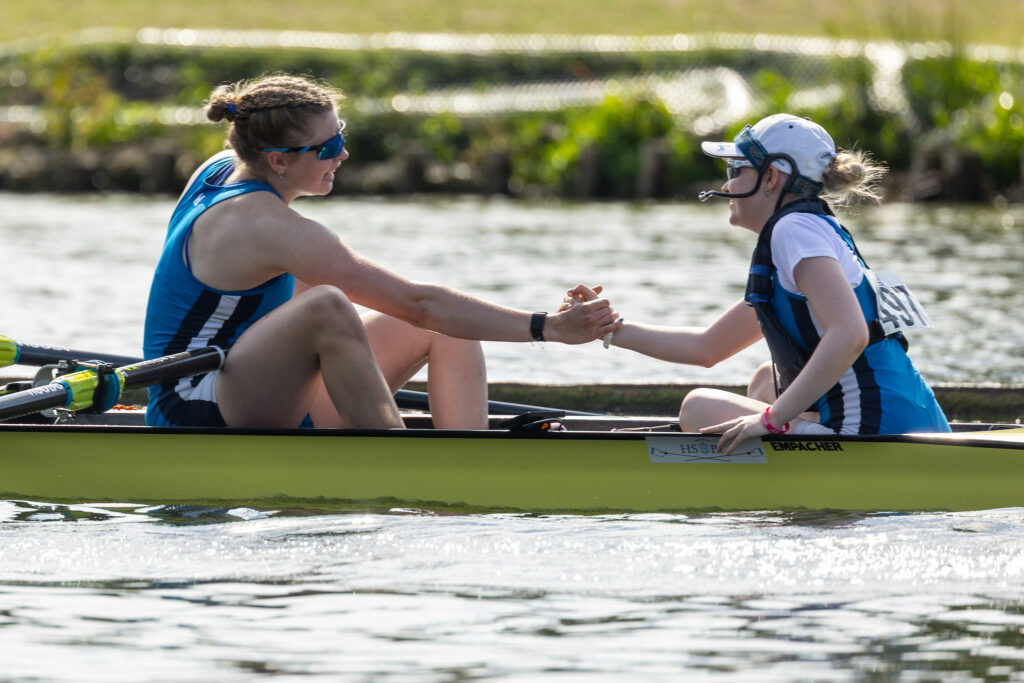 A cox and a rower fist bump after winning at HWR