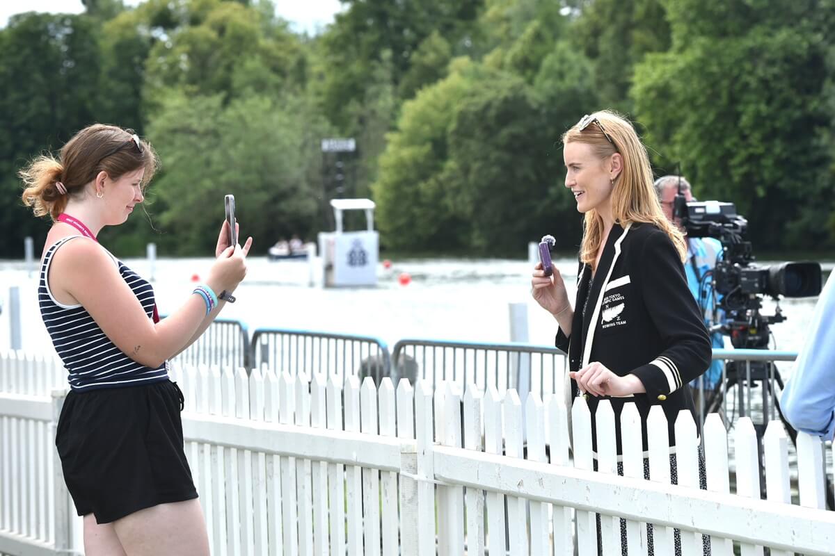 Woman in blazer being filmed doing interview