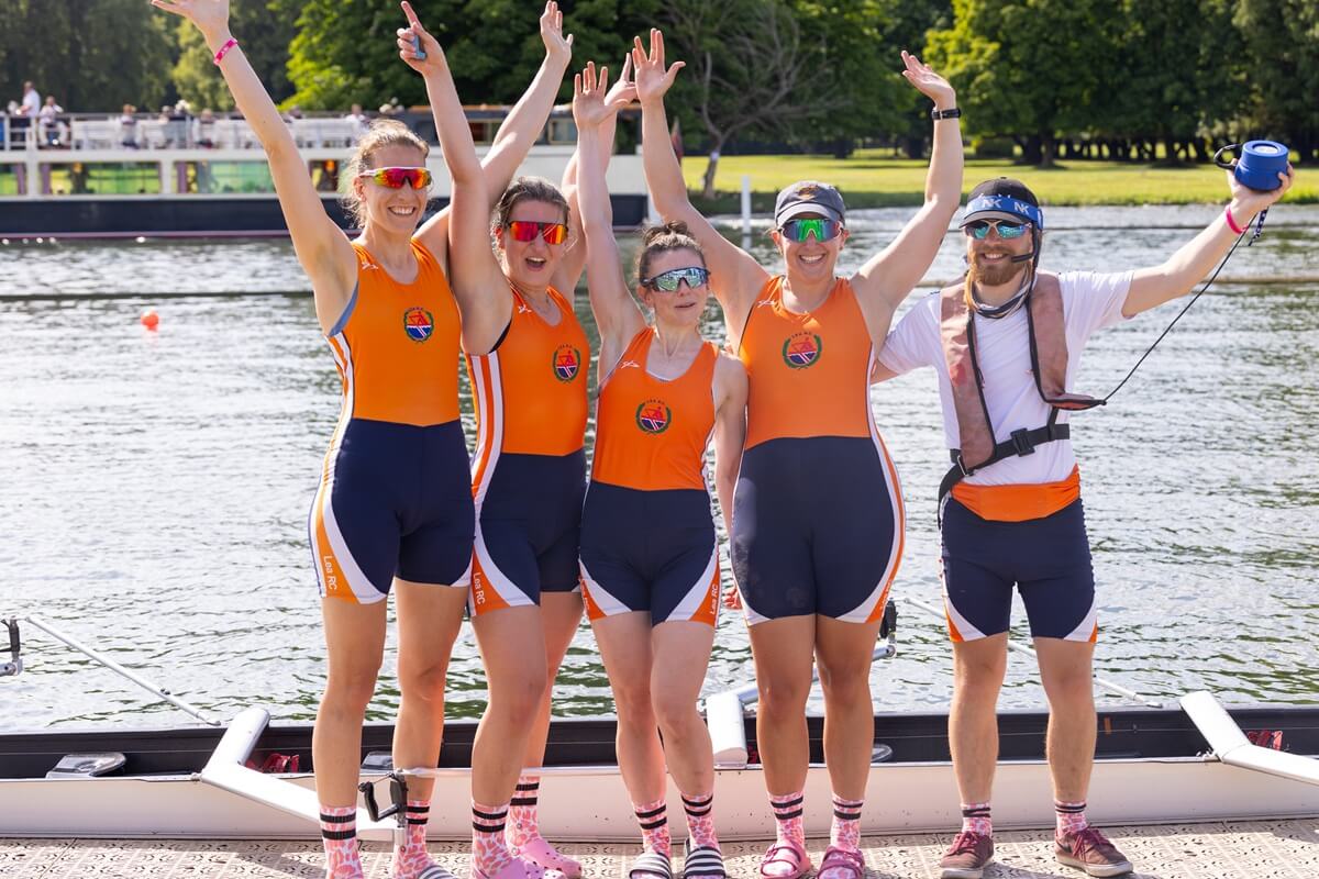 Crew in orange kit waving hands in air in celebration