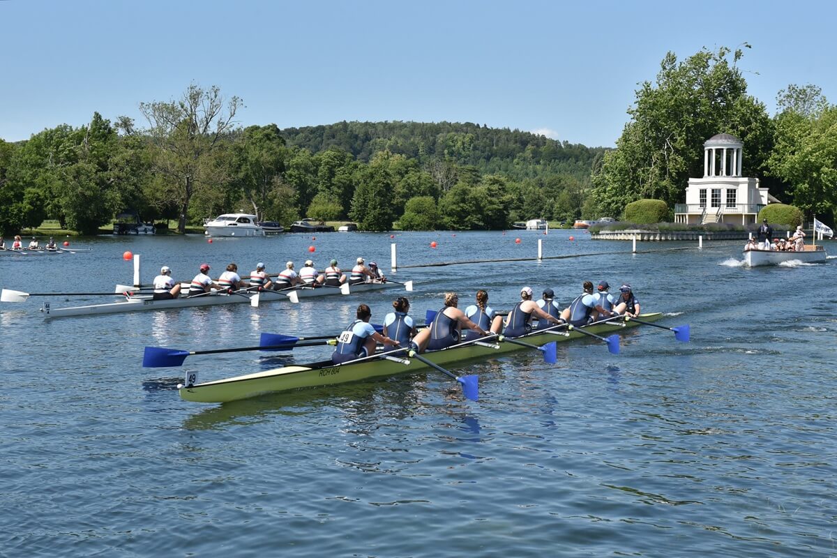 crews racing above Temple island with umpire launch
